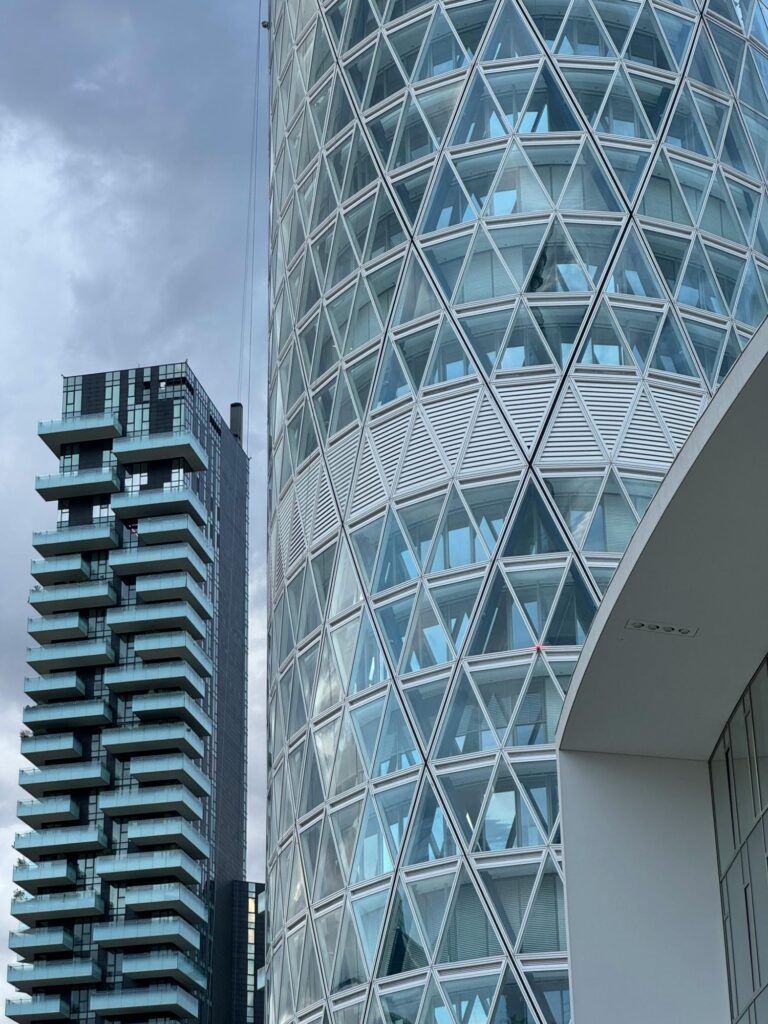 High-rise building with a sleek, modern glass design and stunning reflective façade